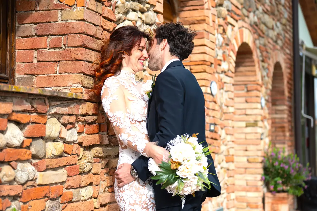 Bride and groom in front of the old farmhouse at Casa d’Era